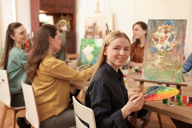 Photo of Group of women learning to draw at table in class