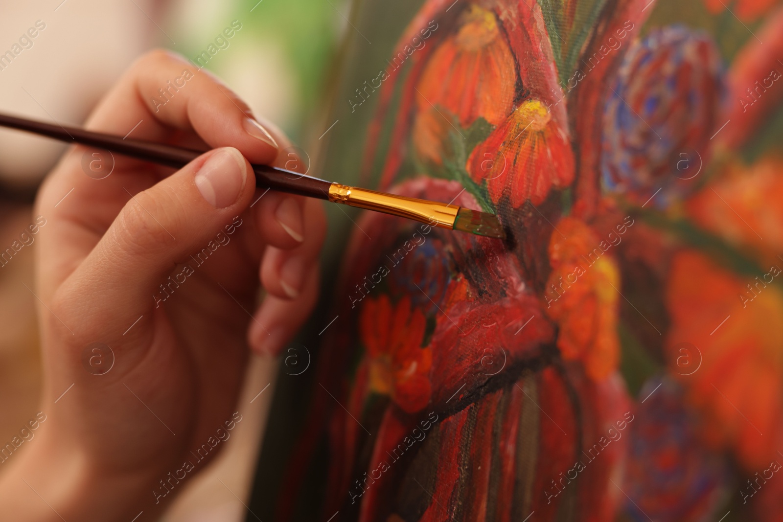 Photo of Woman learning to draw with brush on blurred background, closeup