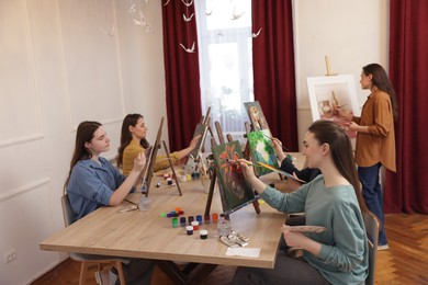 Photo of Group of women learning to draw at table in class