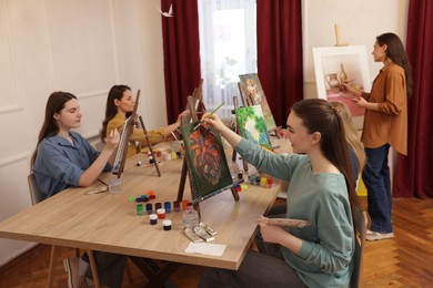 Photo of Group of women learning to draw at table in class