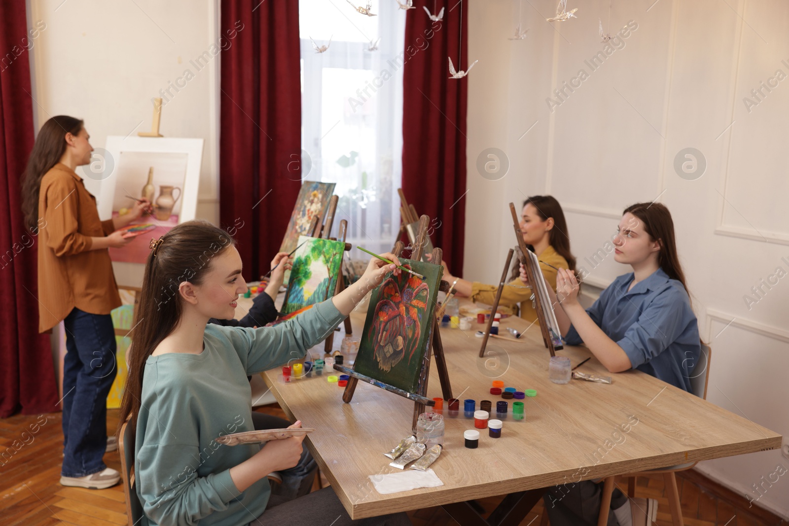 Photo of Group of women learning to draw at table in class