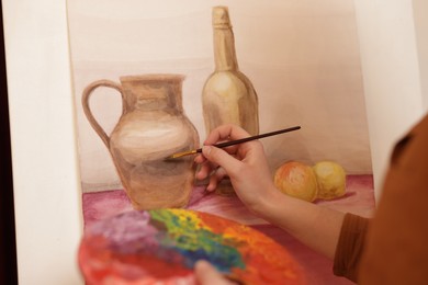 Photo of Woman with palette and brush learning to draw, closeup