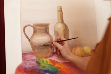 Photo of Woman with palette and brush learning to draw, closeup