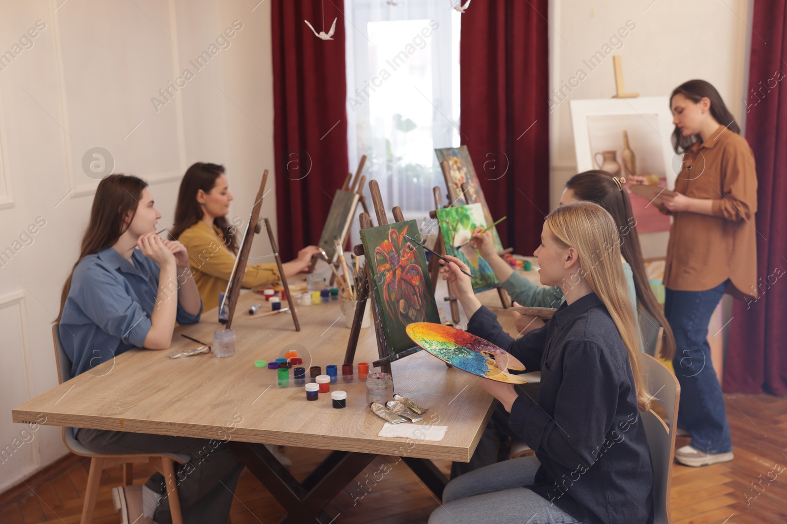 Photo of Group of women learning to draw at table in class