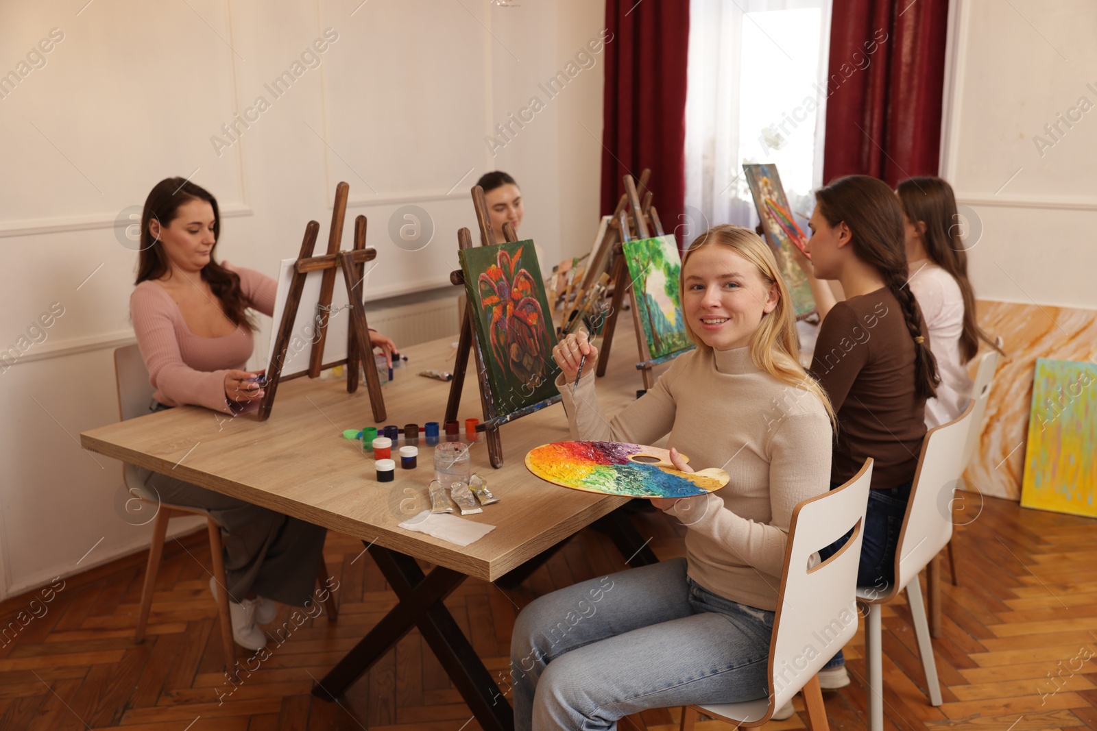 Photo of Group of women learning to draw at table in class