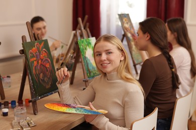 Photo of Group of women learning to draw at table in class