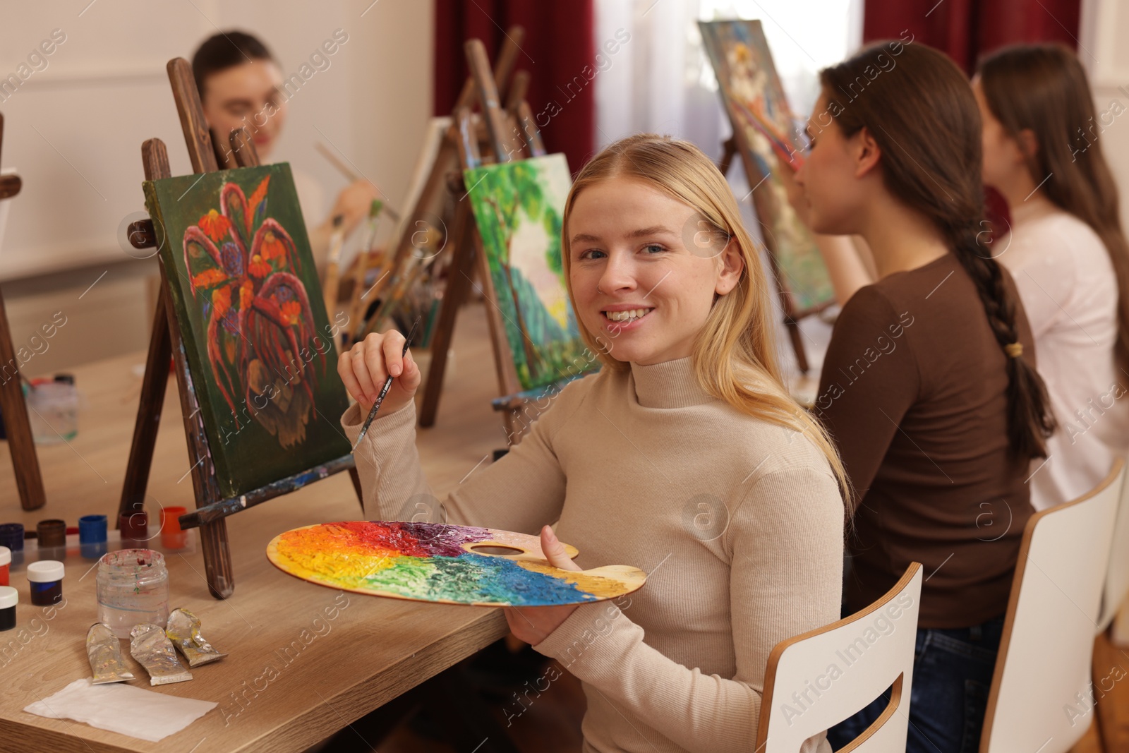 Photo of Group of women learning to draw at table in class