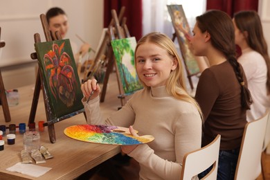 Photo of Group of women learning to draw at table in class