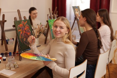 Photo of Group of women learning to draw at table in class