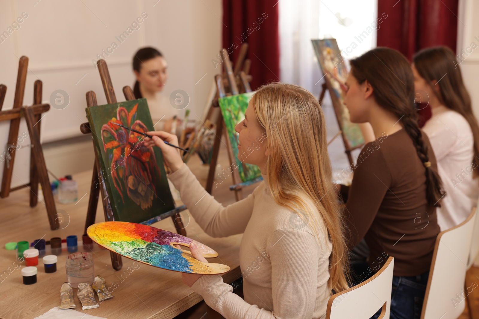 Photo of Group of women learning to draw at table in class