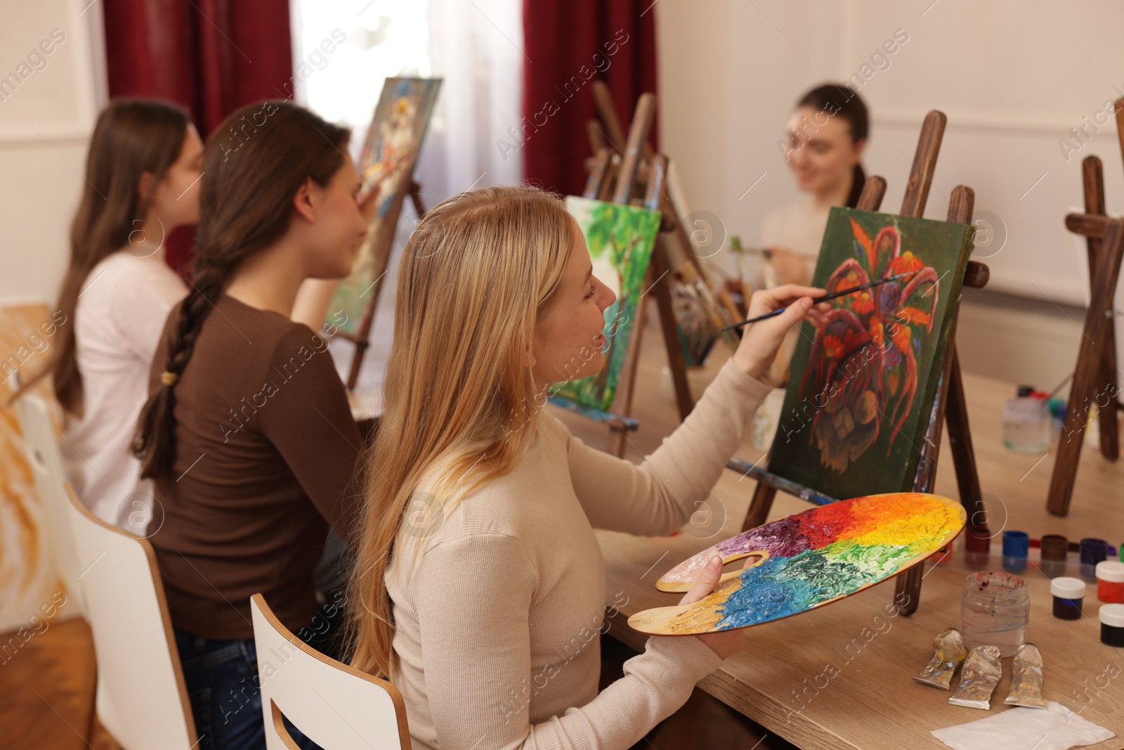 Photo of Group of women learning to draw at table in class