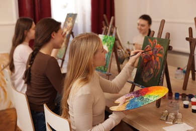 Photo of Group of women learning to draw at table in class