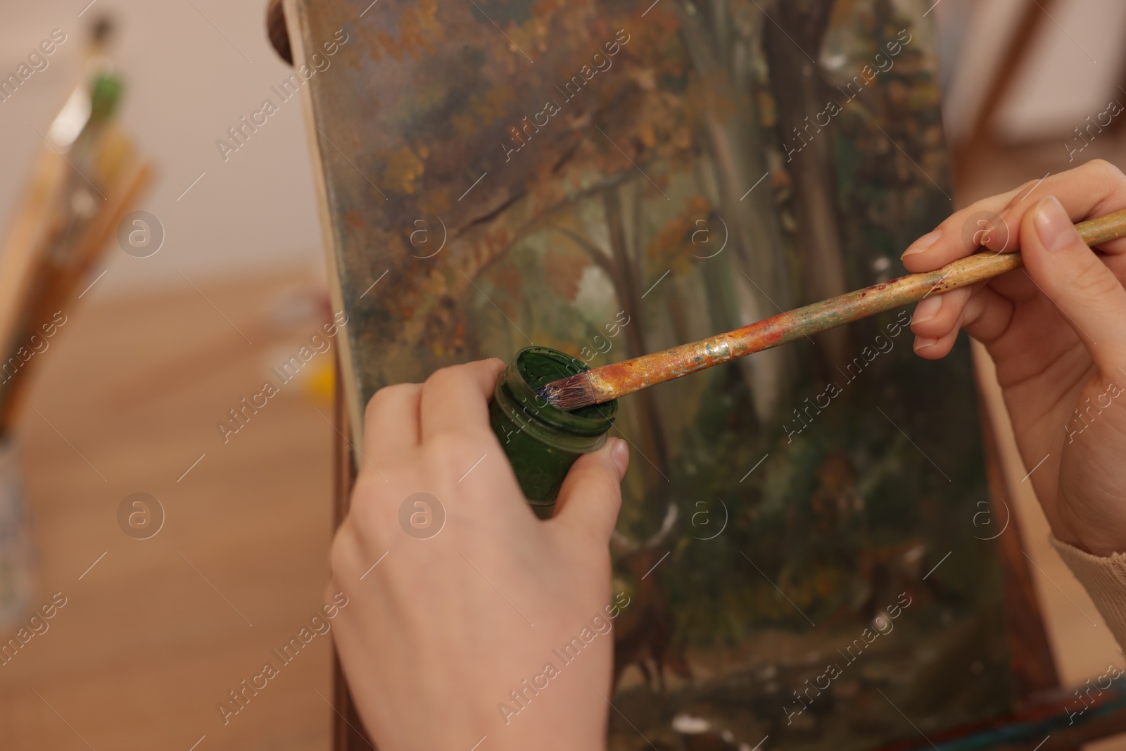 Photo of Woman with brush and paint learning to draw in class, closeup