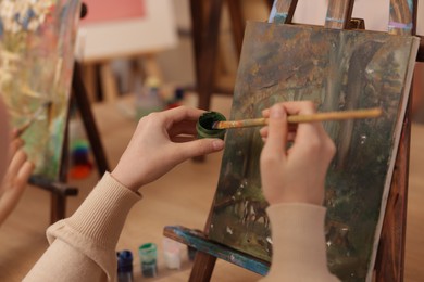 Photo of Woman with brush and paint learning to draw in class, closeup