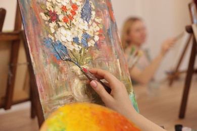 Photo of Woman with painting knife learning to draw at table in class, closeup