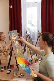 Photo of Women learning to draw at table in class, closeup