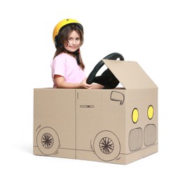 Photo of Little girl driving car made with cardboard on white background