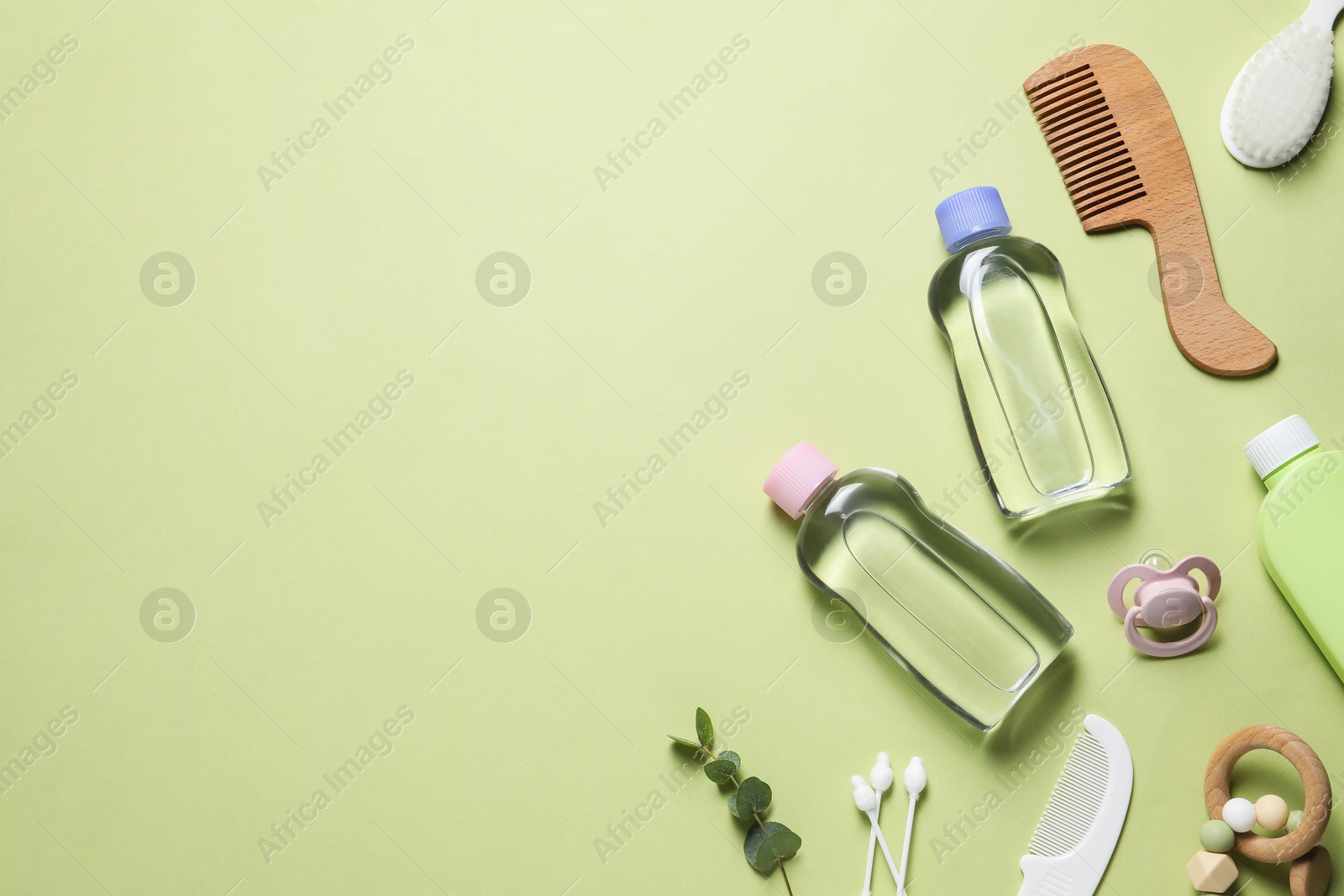 Photo of Baby oil and bath accessories on light background, flat lay. Space for text