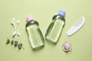 Photo of Baby oil and bath accessories on light background, flat lay