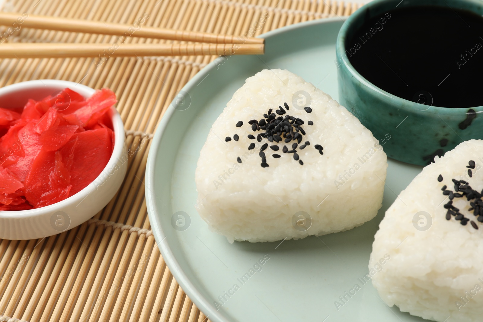 Photo of Rice balls (onigiri) served on table, closeup. Traditional Japanese dish