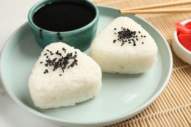 Photo of Rice balls (onigiri) served on table, closeup. Traditional Japanese dish