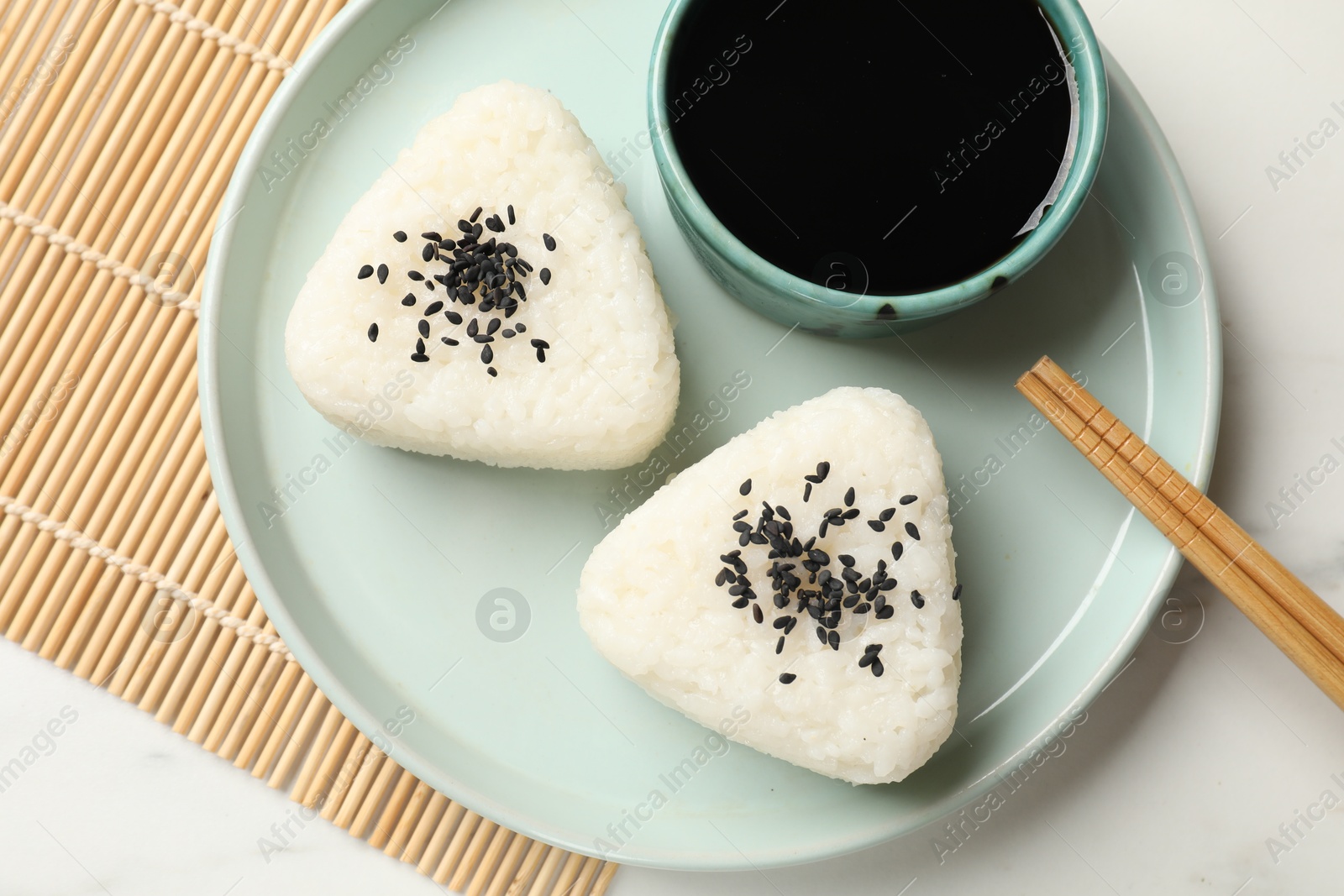 Photo of Rice balls (onigiri) served on light table, top view. Traditional Japanese dish