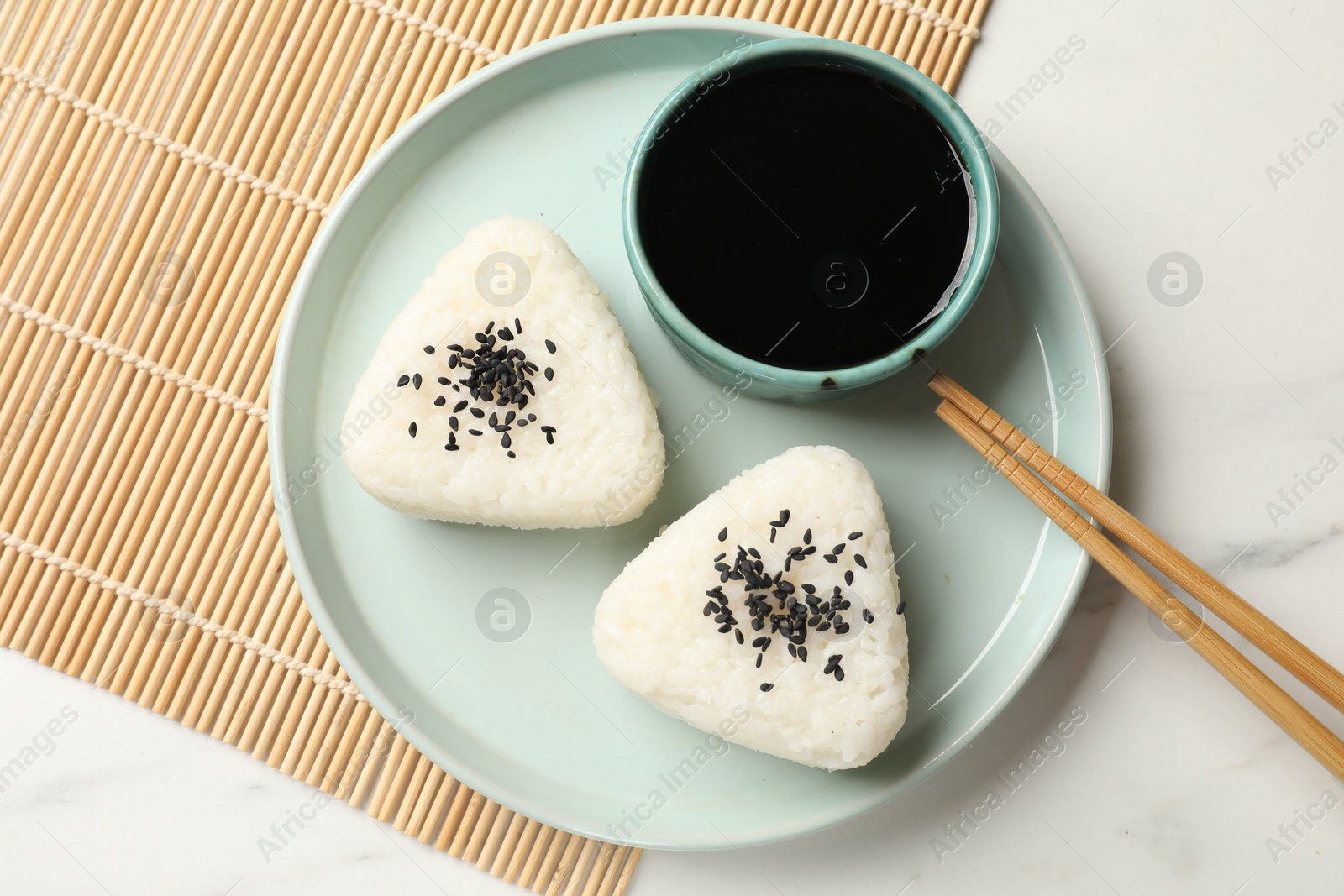 Rice balls (onigiri) served on light table, top view. Traditional Japanese dish Photo of Rice balls (onigiri) served on light table, top view. Traditional Japanese dish