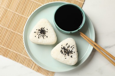 Photo of Rice balls (onigiri) served on light table, top view. Traditional Japanese dish