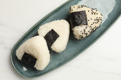 Photo of Rice balls (onigiri) on light table, top view. Traditional Japanese dish