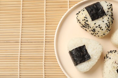 Photo of Rice balls (onigiri) on table, top view and space for text. Traditional Japanese dish