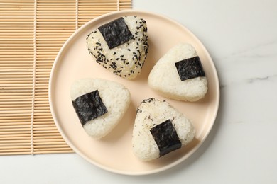 Photo of Rice balls (onigiri) on light table, top view. Traditional Japanese dish