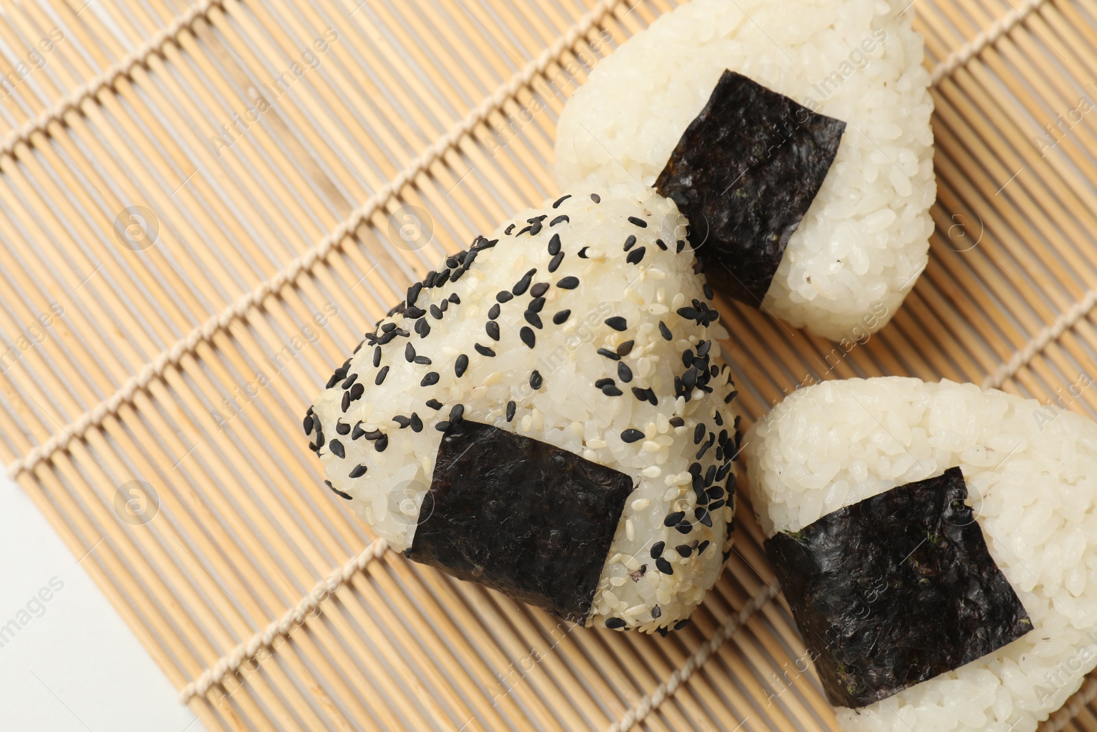 Photo of Rice balls (onigiri) on table, flat lay. Traditional Japanese dish