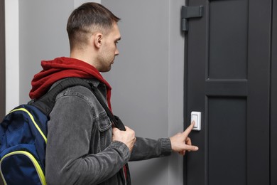 Photo of Man ringing doorbell of his friends apartment