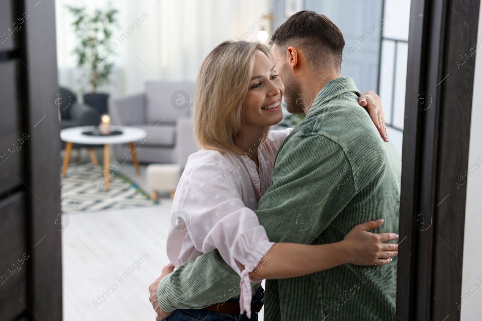 Photo of Happy woman welcoming friend to her apartment