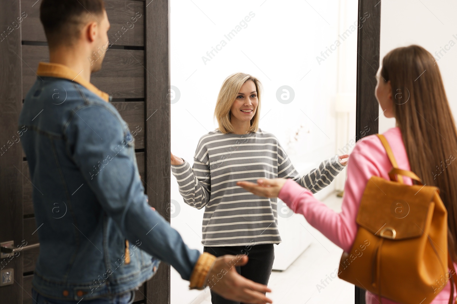 Photo of Woman welcoming new neighbors to her apartment