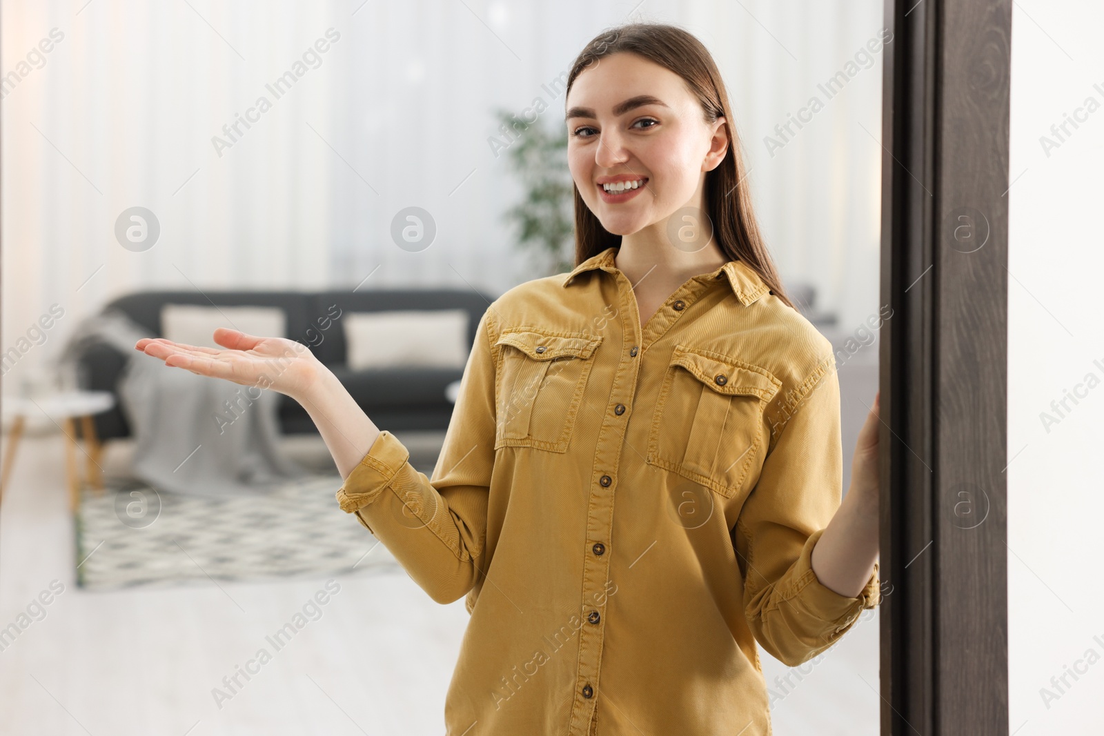 Photo of Happy woman welcoming friend to her house