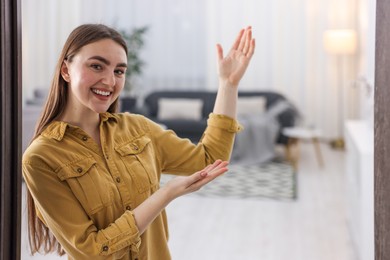 Photo of Happy woman welcoming friend to her house