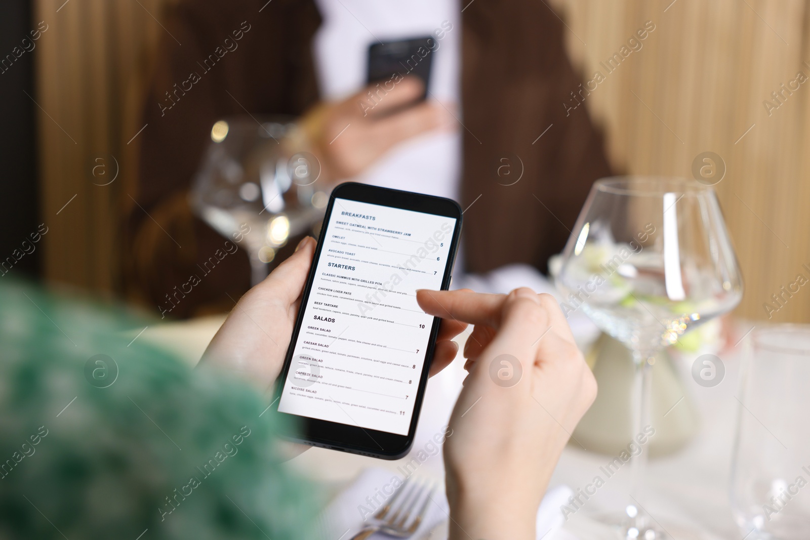 Photo of Couple choosing dishes from digital menu at restaurant, closeup