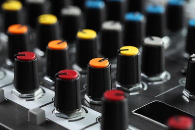 Photo of Professional mixing console, closeup. Radio studio equipment