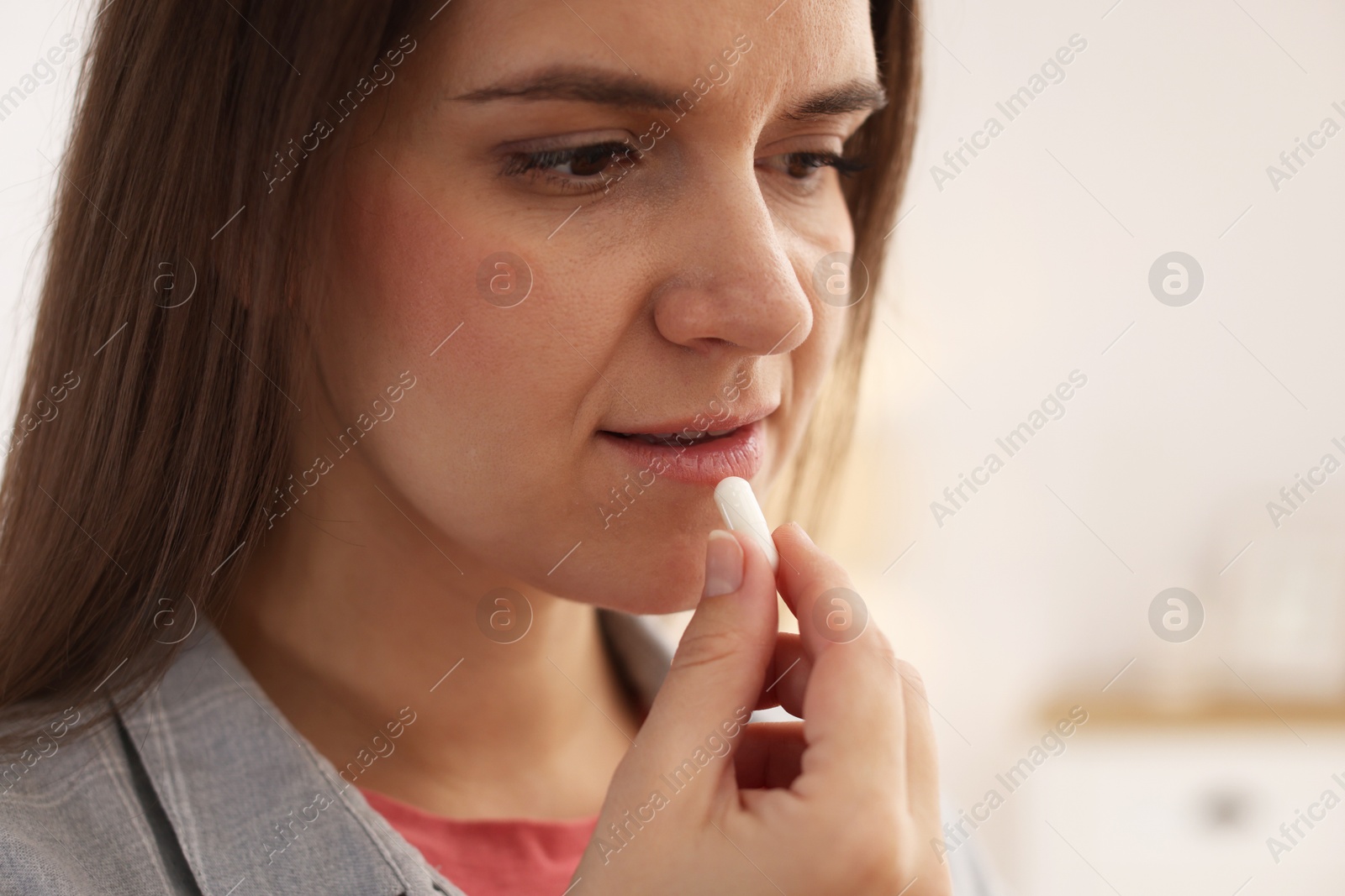 Photo of Woman taking medical pill at home, space for text