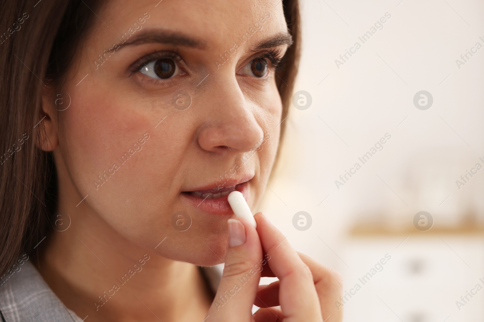 Photo of Woman taking medical pill at home, space for text