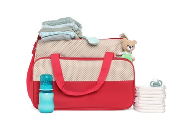 Photo of Mother's bag with baby's stuff isolated on white