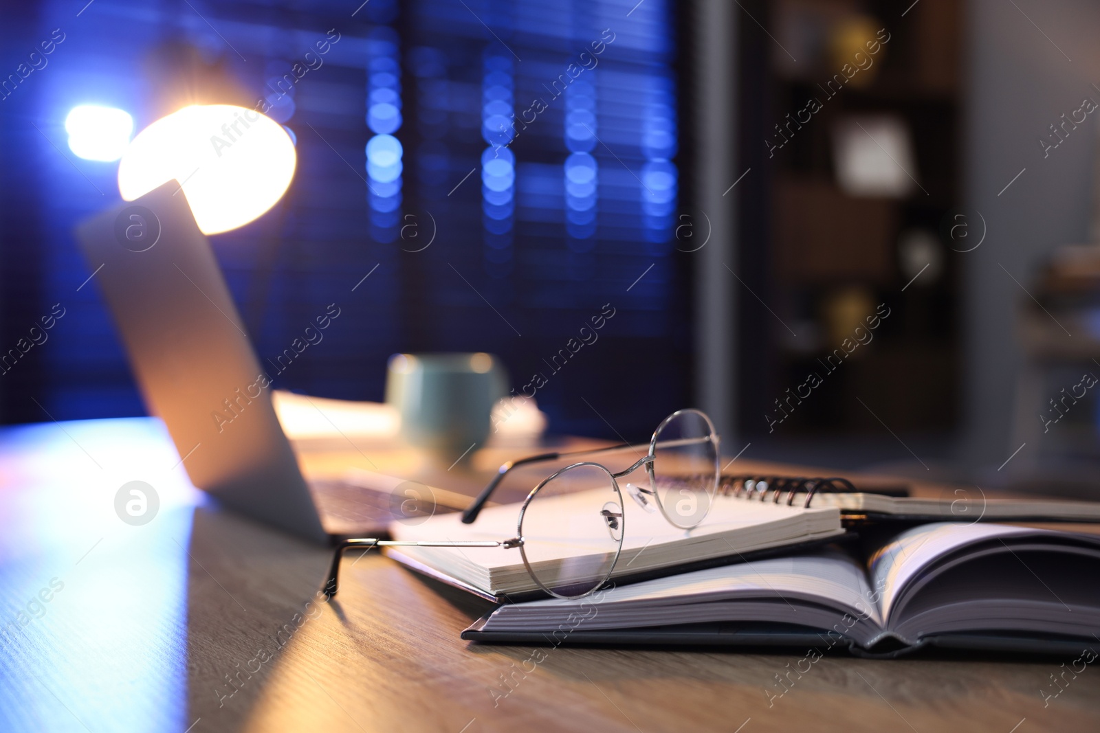 Photo of Workspace with laptop on wooden desk in home office, selective focus. Space for text