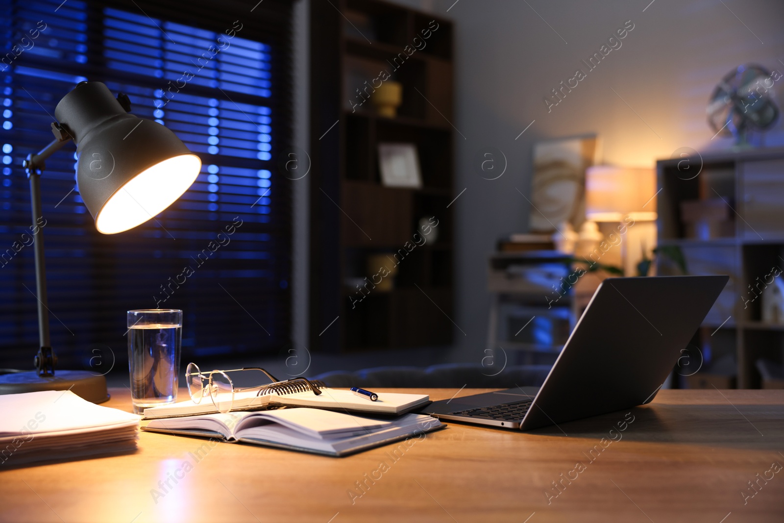 Photo of Workspace with laptop on wooden desk in home office. Space for text