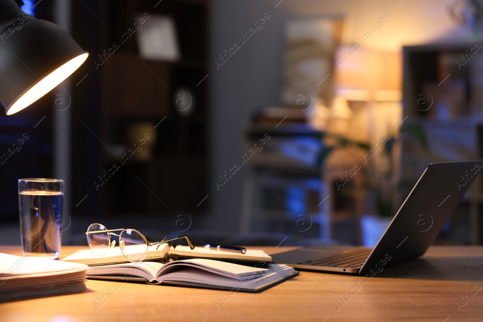 Photo of Workspace with laptop on wooden desk in home office. Space for text