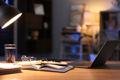 Photo of Workspace with laptop on wooden desk in home office. Space for text