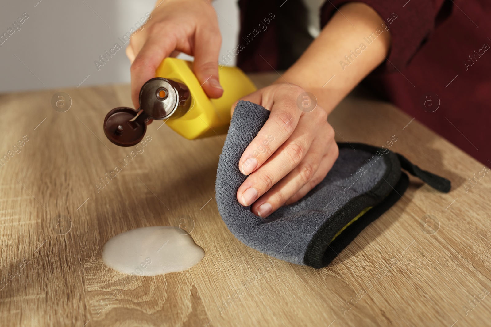 Photo of Woman polishing wooden table at home, closeup