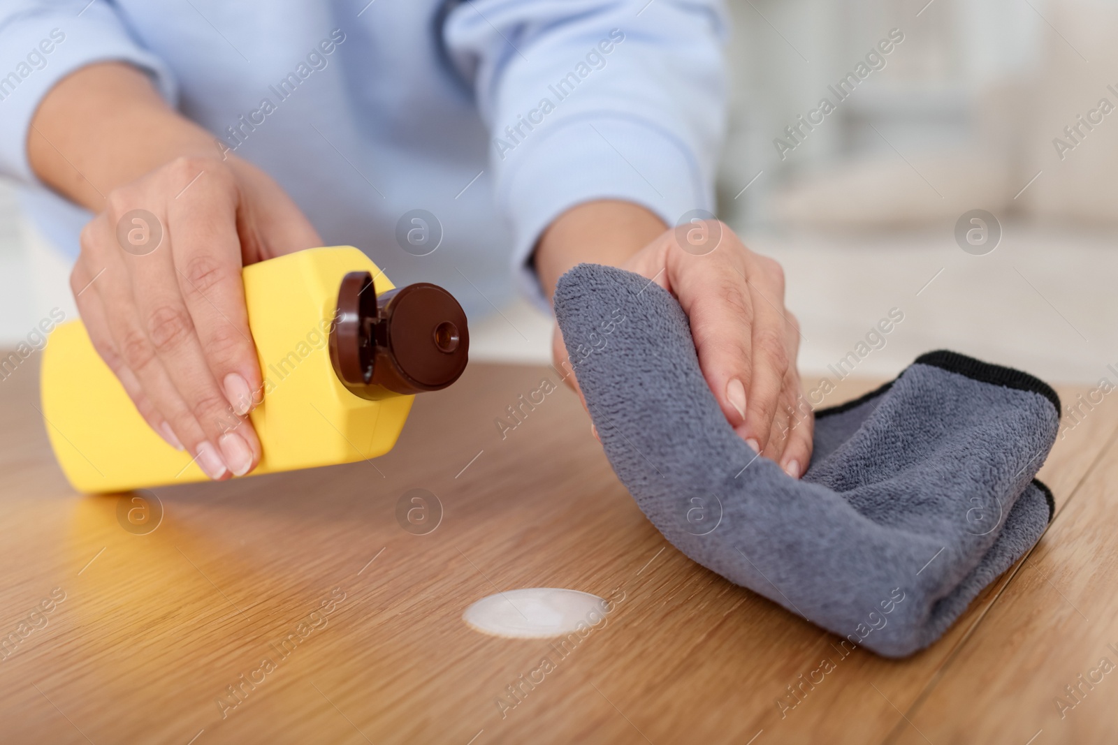 Woman polishing wooden table at home, closeup Photo of Woman polishing wooden table at home, closeup