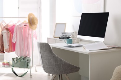 Photo of Home office. Comfortable workplace near white wall. Desk with computer and other furniture in room