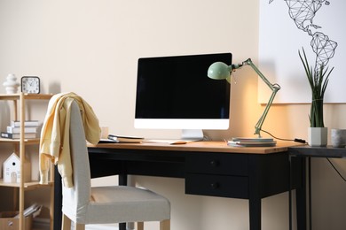 Photo of Comfortable workplace with modern computer in home office